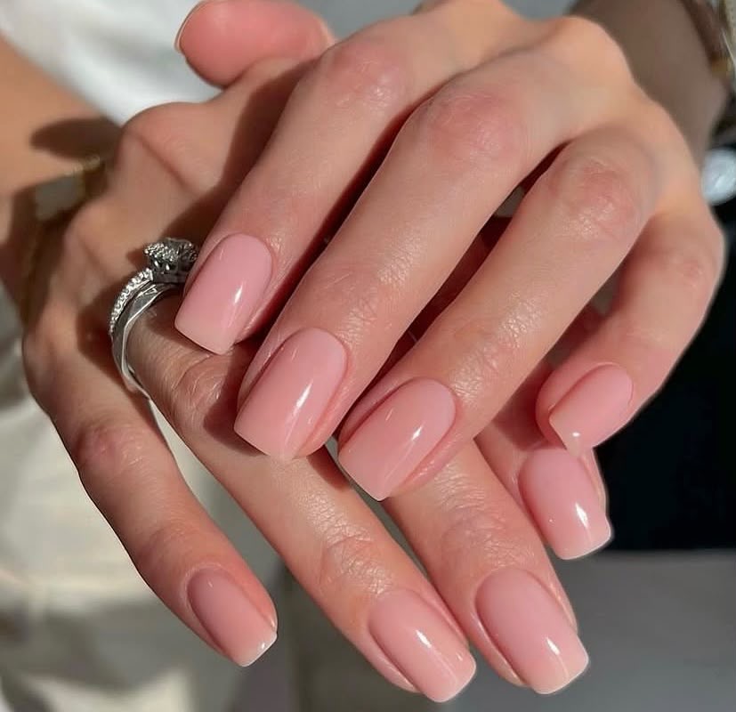 Unhas naturais em tom nude sobre tricô bege